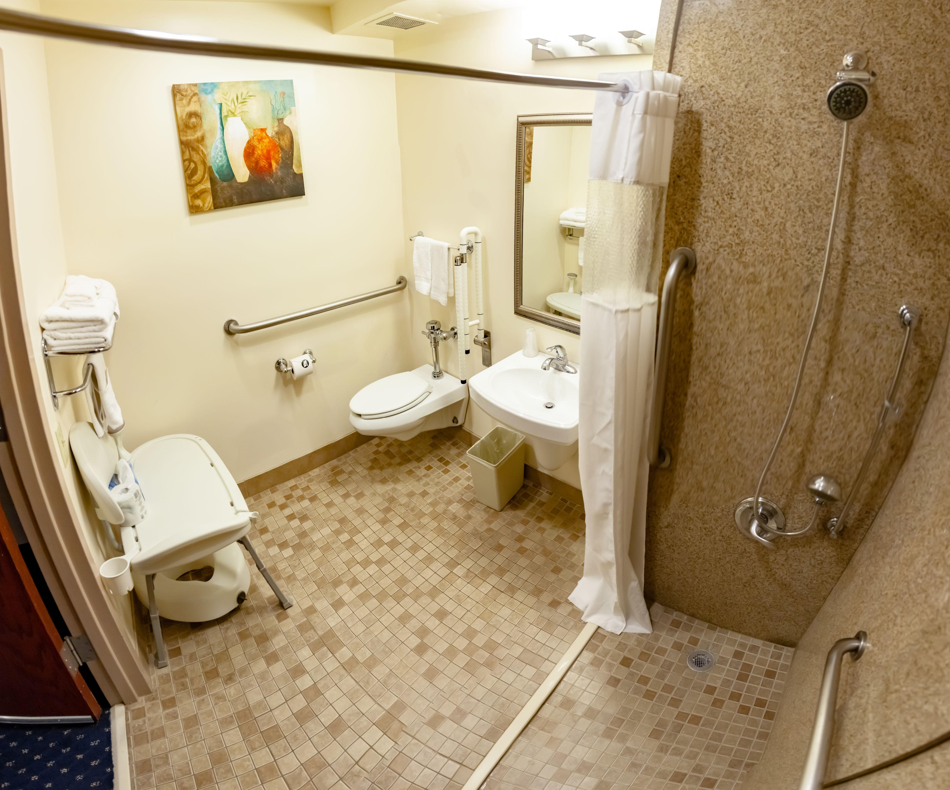 A bathroom with a toilet, sink, and shower.