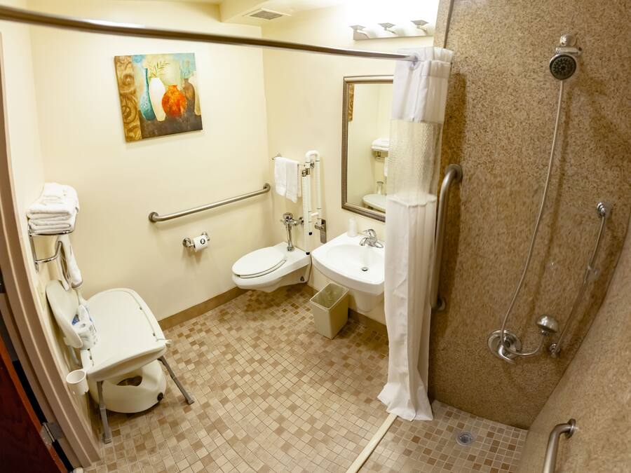 A bathroom with a toilet, sink, and shower.