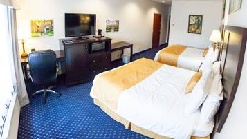 A hotel room with two beds, a desk with a television, a chair, and a waste bin.