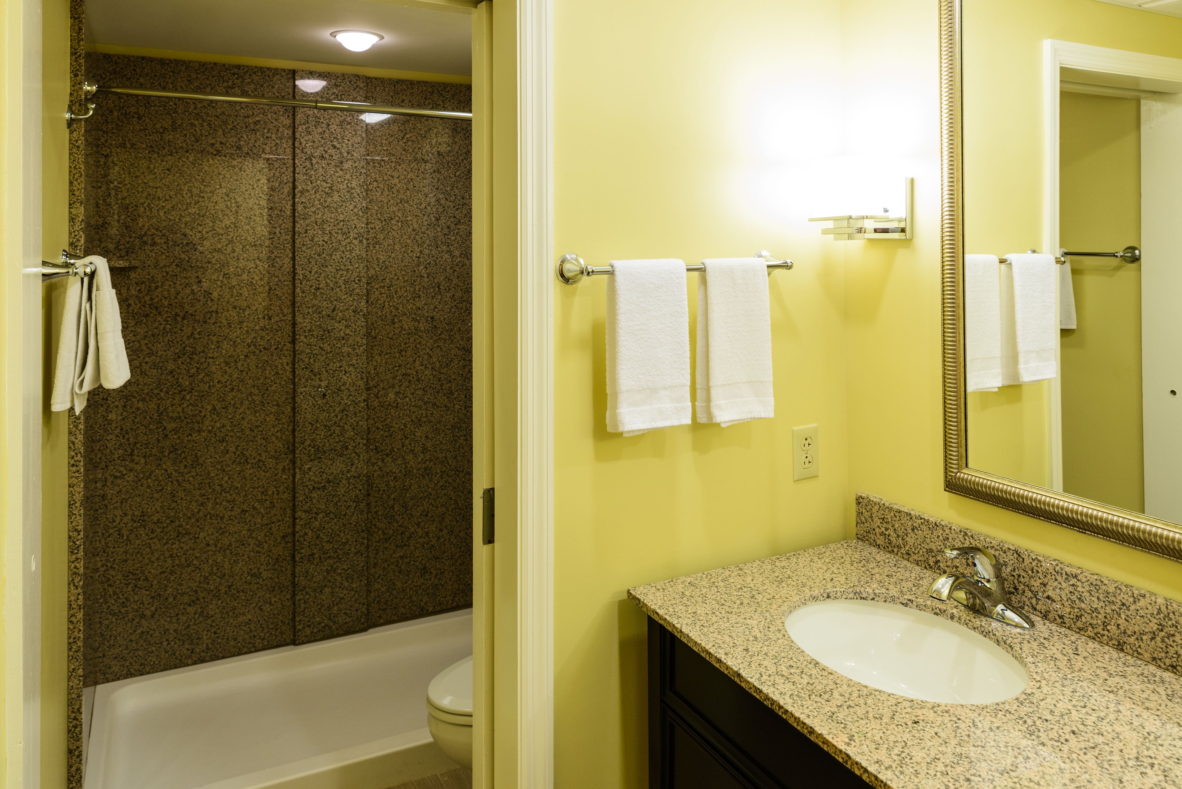 A bathroom with a bathtub, toilet, and sink.