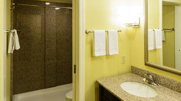 A bathroom with a bathtub, toilet, and sink.