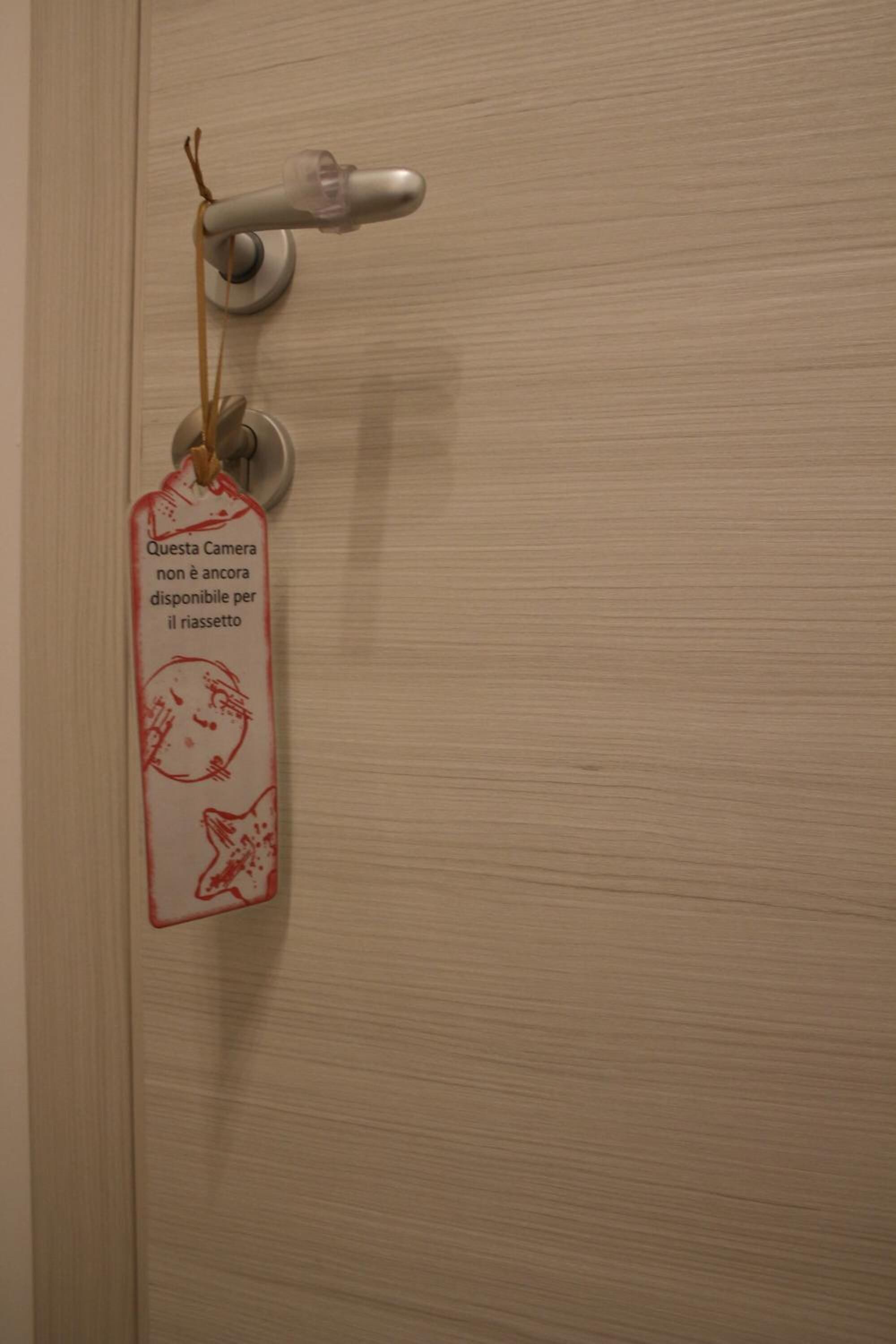 A door with a lock and a tag hanging on it.