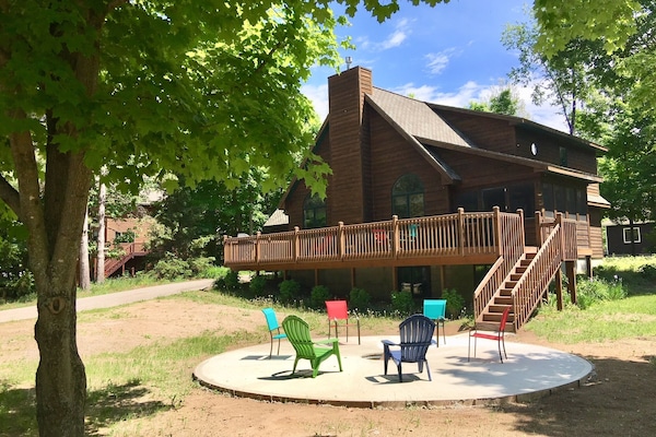 Front of house with large in-ground firepit.