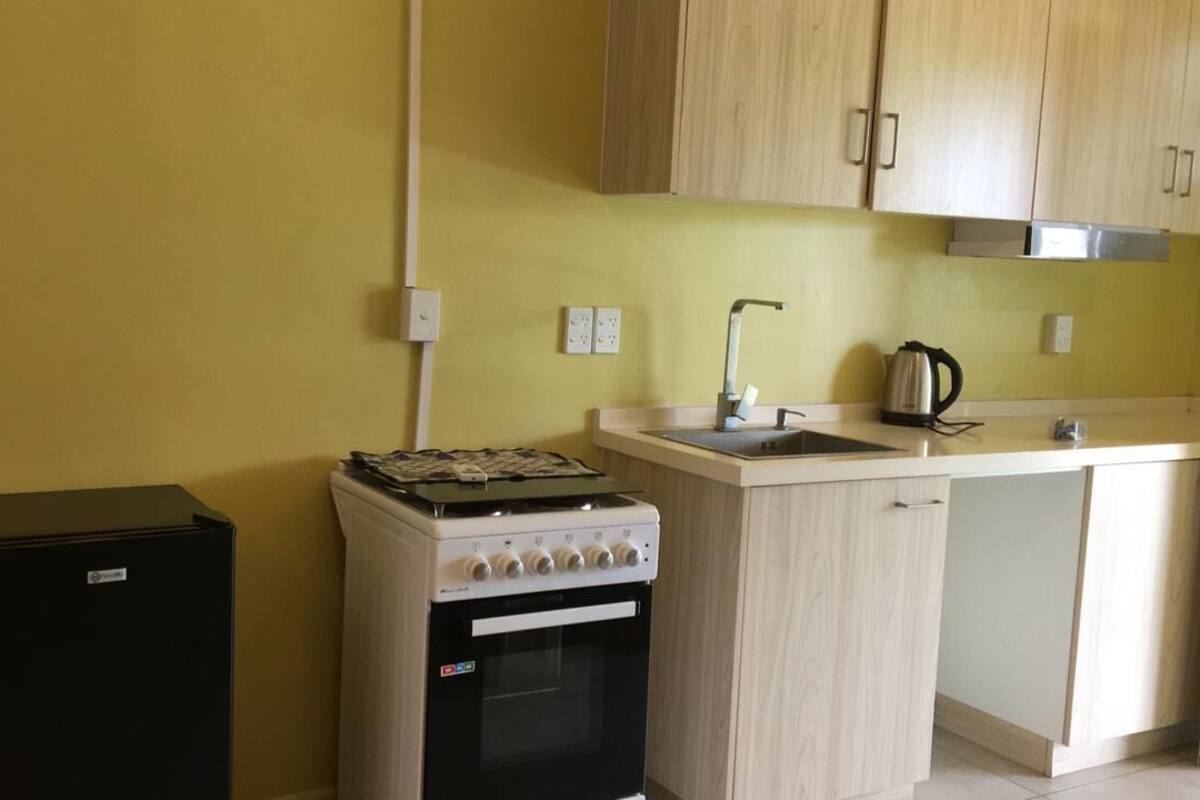 comfort studio suite, accessible, ground floor | private kitchen | oven, electric kettle, toaster, cleaning supplies