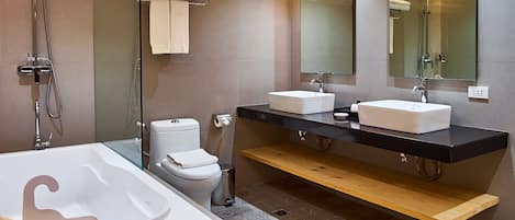 A modern bathroom with a freestanding bathtub, a double sink vanity, and a large mirror above the vanity.