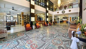 A spacious lobby with a patterned carpet, multiple seating areas, and a high ceiling with natural light. - Coco Retreat Phuket Resort and Spa Sha+ (Chalong)