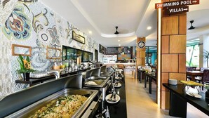 A buffet area with multiple food stations, a clock, and directional signs for amenities like the swimming pool and villas. - Coco Retreat Phuket Resort and Spa Sha+ (Chalong)