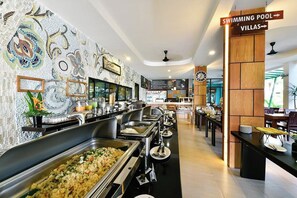 A buffet area with multiple food stations, a clock, and directional signs for amenities like the swimming pool and villas. - Coco Retreat Phuket Resort and Spa Sha+ (Chalong)