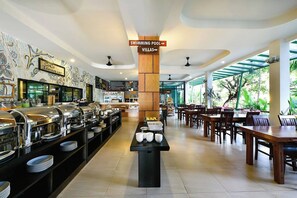 A hotel restaurant with buffet, dining tables, and a sign indicating a swimming pool and villas. - Coco Retreat Phuket Resort and Spa Sha+ (Chalong)