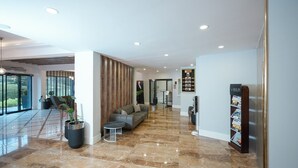 A modern lobby with a seating area, a reception desk, and a display board. - Hilas Thermal Resort & Spa (Samsun)