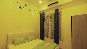 A bedroom with a bed, a window with curtains, a wardrobe, and a ceiling light.