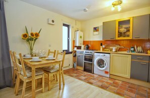 Full-sized fridge, microwave, coffee/tea maker, cookware/dishes/utensils