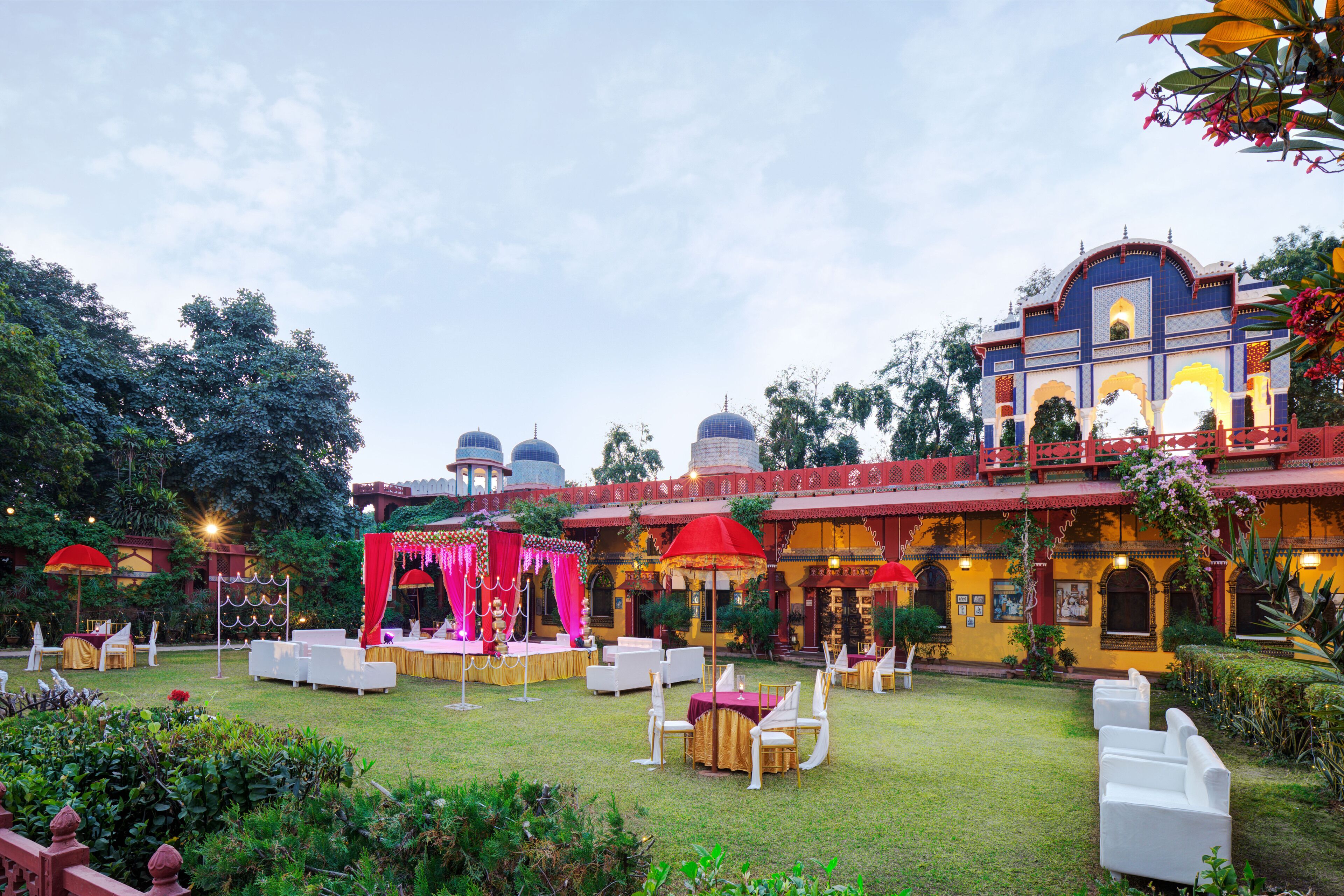 An outdoor garden with seating areas and a stage for events.