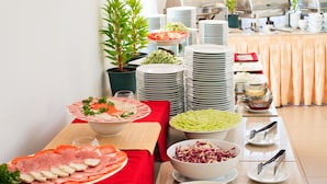 A buffet setup with various food items and utensils. - Paragon Villa Hotel (Nam Nha Trang)