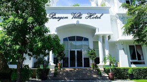 The Paragon Villa Hotel entrance with a grand archway, steps leading up to the doors, and potted plants around. - Paragon Villa Hotel (Nam Nha Trang)