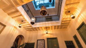 A room with a high ceiling, ornate ceiling design, and multiple hanging light fixtures. - Riad Dar Tiflet (Marrakech)