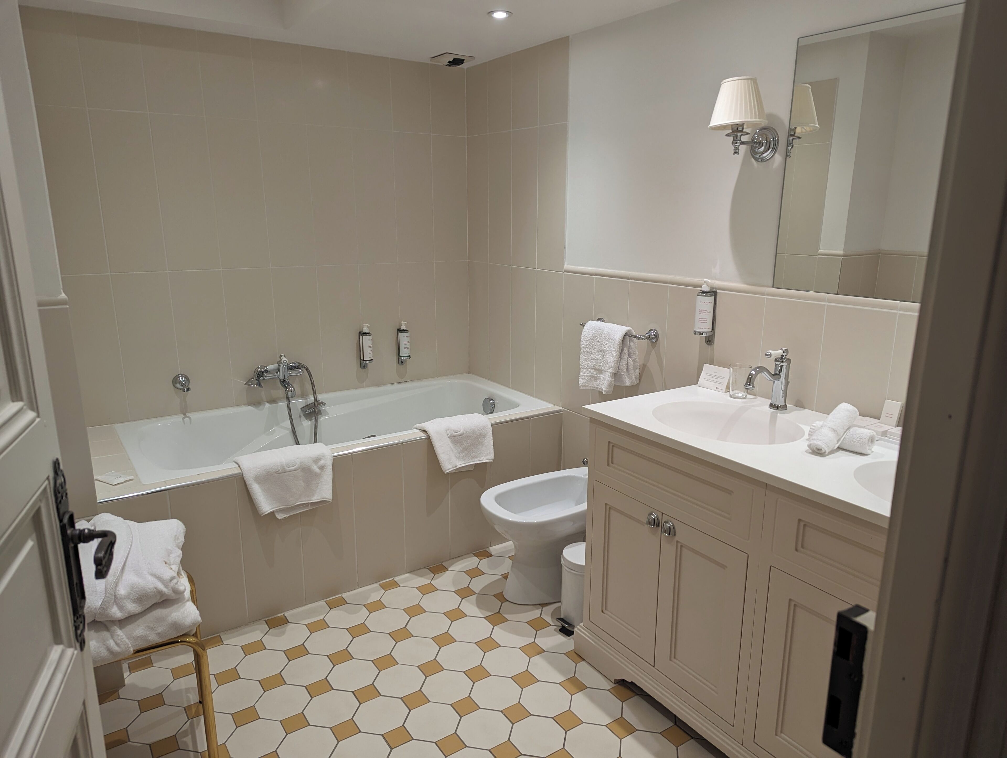 A modern bathroom with a bathtub, a toilet, and a sink.