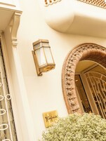 A building entrance with a lantern, an ornate archway, and a 'Confidential' sign.