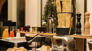 A breakfast buffet with various food items, a coffee station, and a toaster. - 9Confidentiel (Paris)