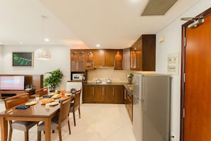 Enjoy cooking in this well-equipped kitchen with a dining area and appliances.