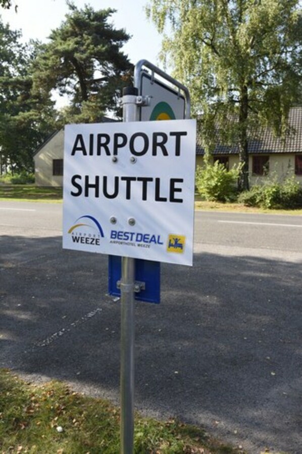 A sign for an airport shuttle service.