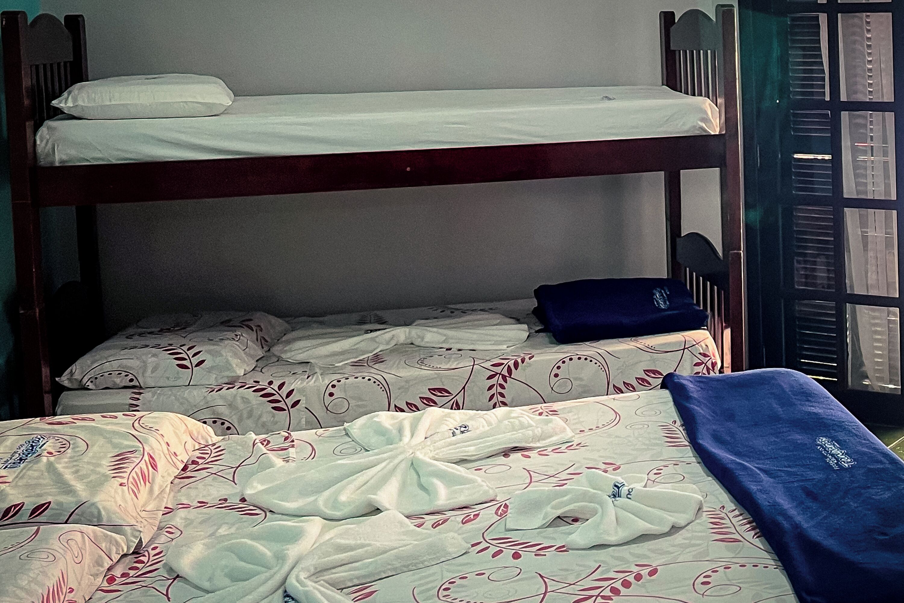 A bunk bed with a lower bunk and a single bed below.