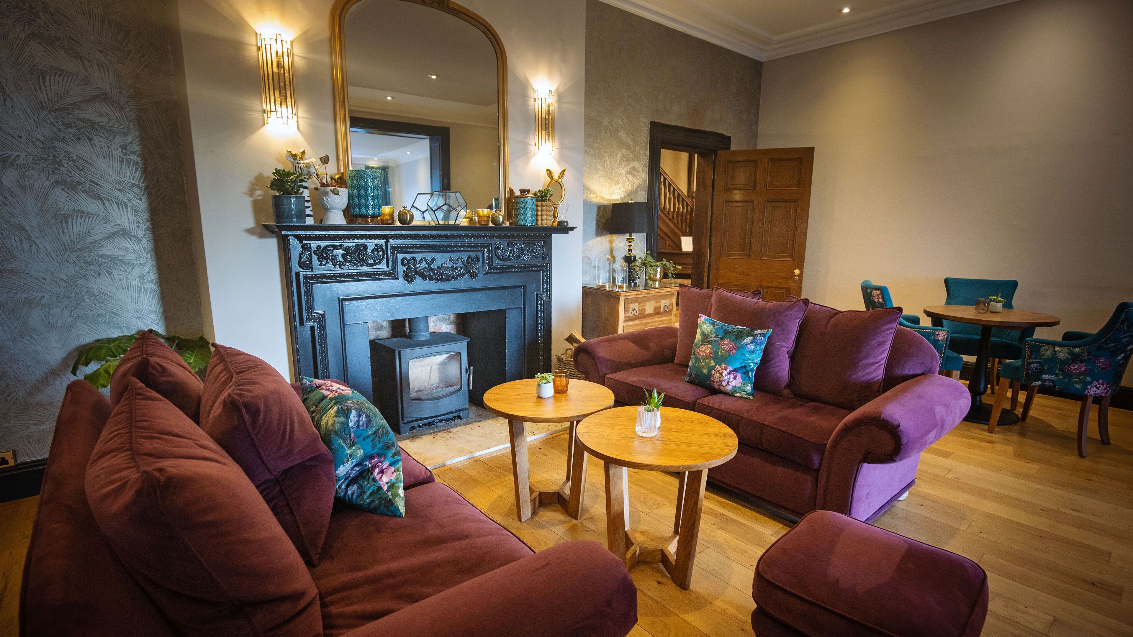 A living room with a fireplace, sofas, and a dining area.