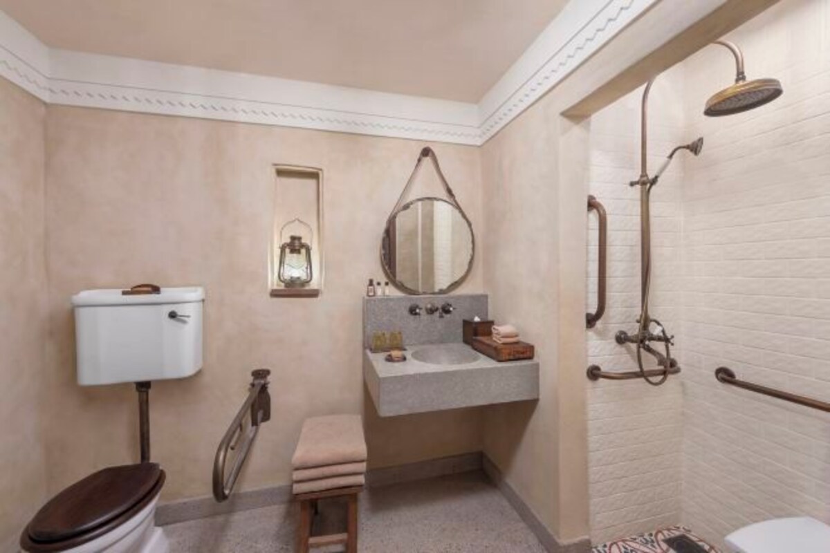 A bathroom with a toilet, sink, and shower.