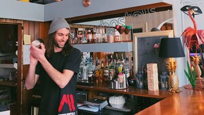 A bar area with a variety of bottles and a wooden counter. - Astor York - Hostel (York)