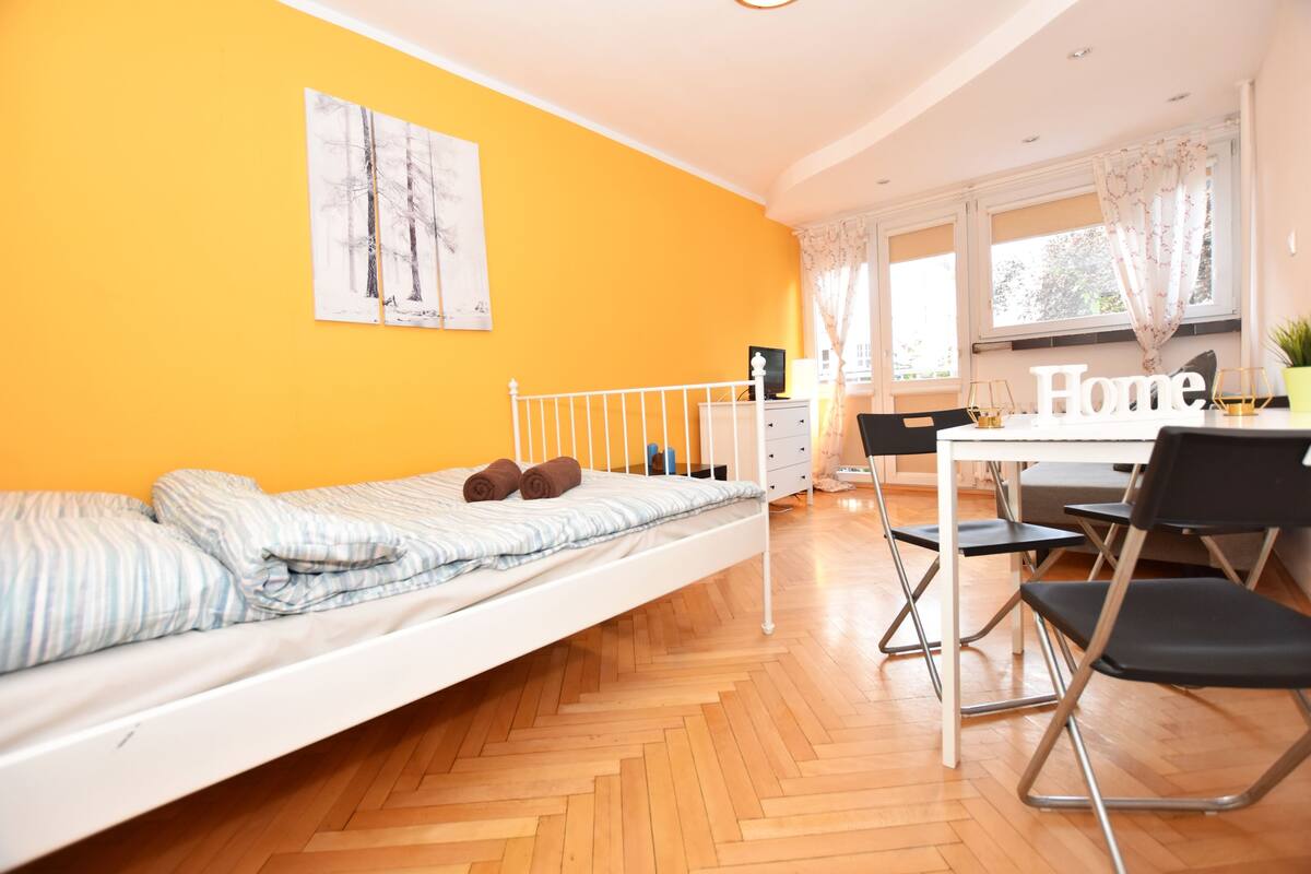 A room with a bed, a desk, and a chair.