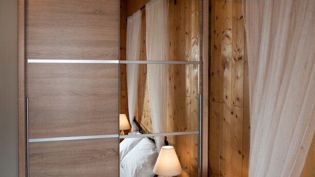 A wooden-framed sliding door with a bed and bedside lamps. - Luxury Loft Lefkas (Lefkada)