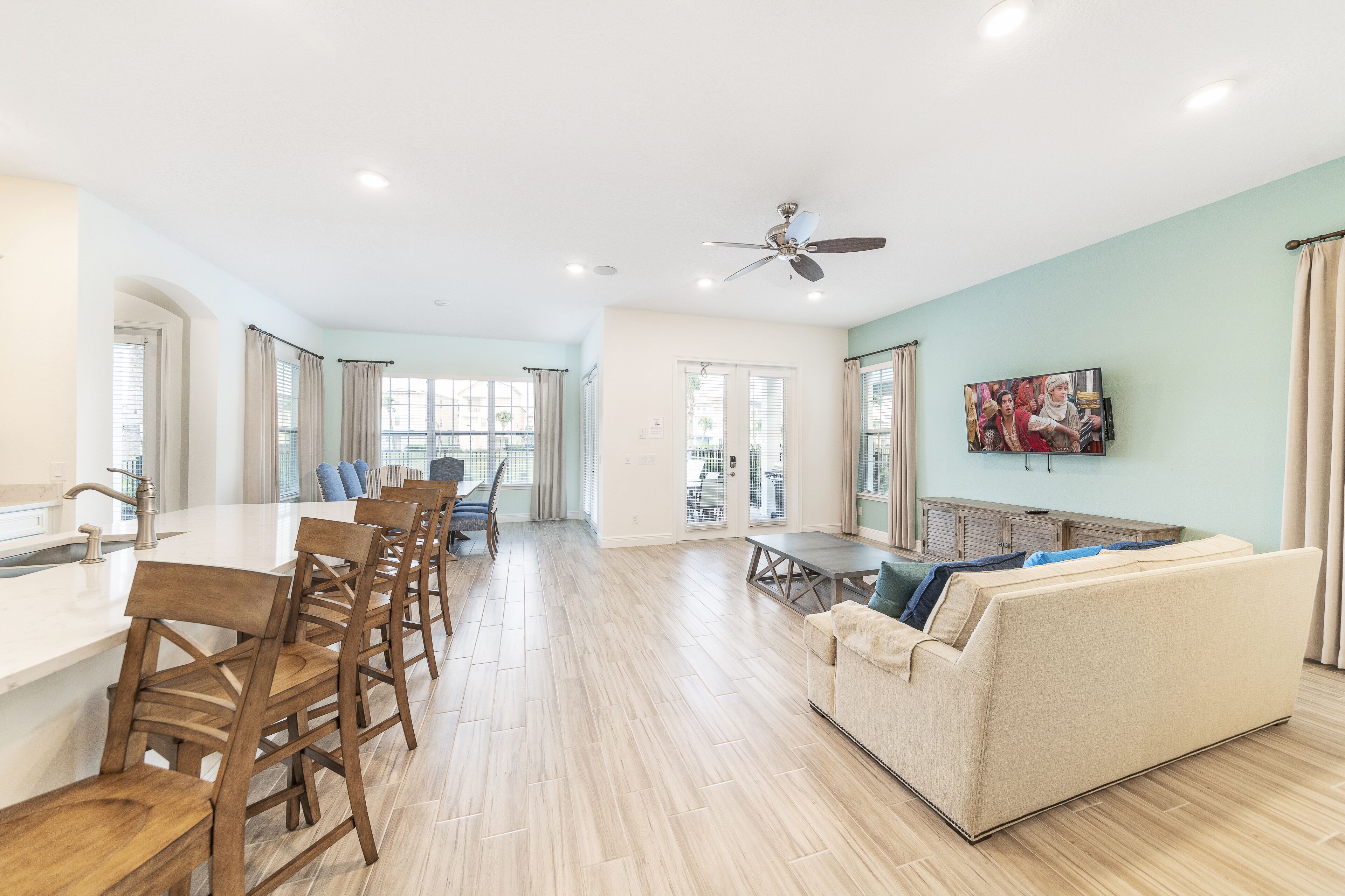 A spacious living area with a kitchen, dining area, and a sofa.