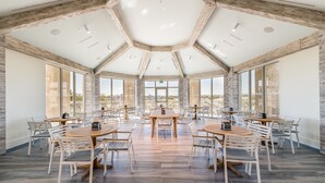 A spacious dining area with hexagonal ceiling and large windows offering views of the city. - Margaritaville Cottages Orlando by Rentyl with H2O Waterpark (Kissimmee)