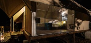 A tented accommodation with a bed, a small table, and a lantern. - Kodev (Kalpitiya)