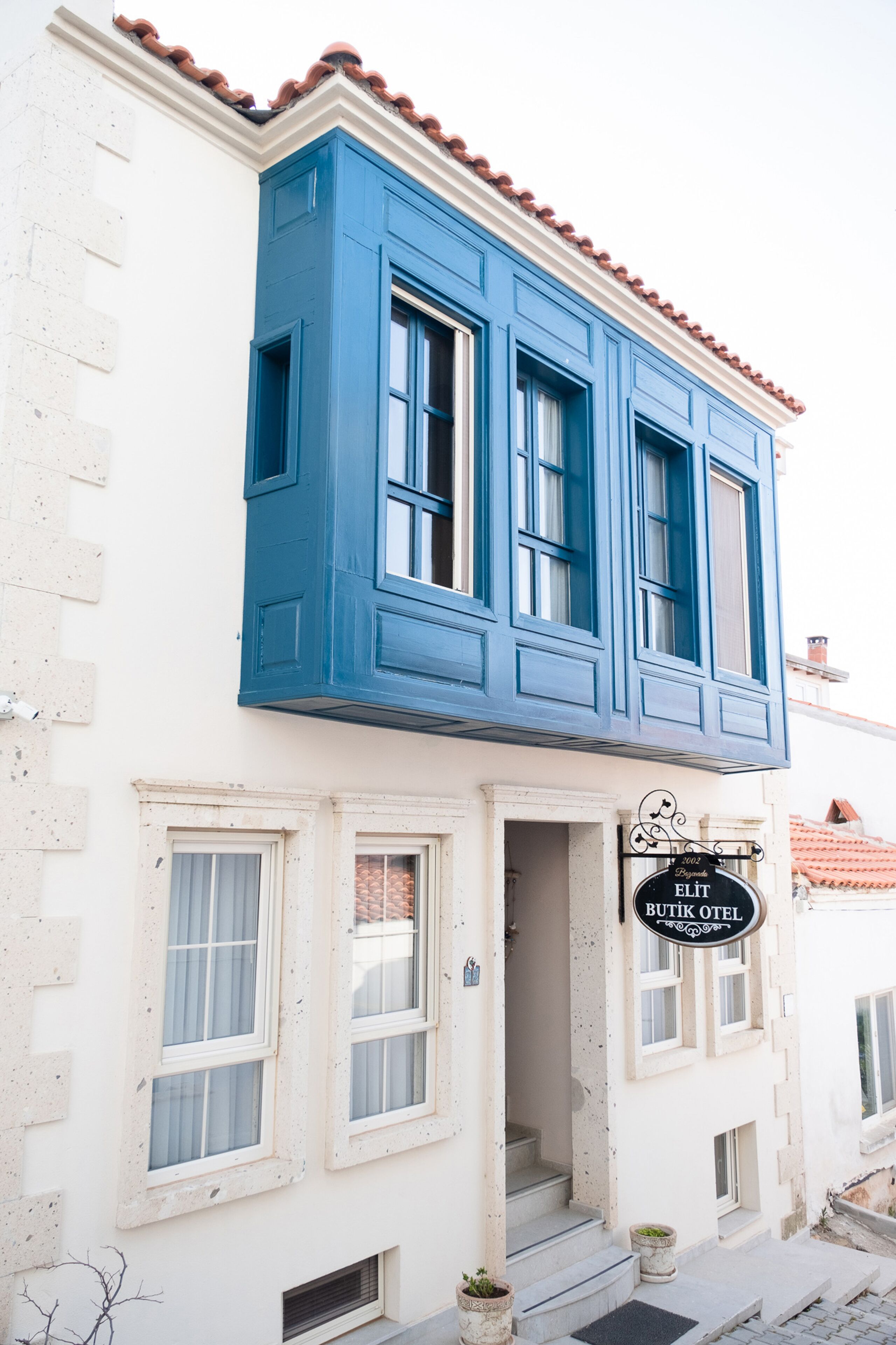 A two-story building with a sign reading "Butik Otel" at the entrance.