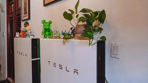 A Tesla charging station with a decorative shelf above it. - Terrace for sunbathing / walking distance to historic sites & cafes (San Juan)