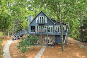 Back view. Deck spans the back of the main level.