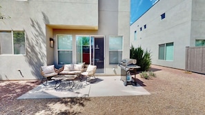 A patio with outdoor furniture, a grill, and a sliding glass door leading to a covered area. - Entrada at Moab - 424b, Spacious 4 Bed 3 Bath House (Moab)