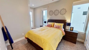 A bedroom with a bed, a nightstand, a lamp, and a window. - Entrada at Moab - 424b, Spacious 4 Bed 3 Bath House (Moab)
