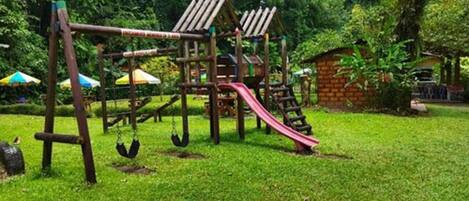 A playground with a slide, swings, and climbing structures.