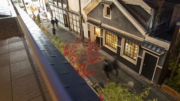 A traditional Japanese building with a sloped roof and a small window.