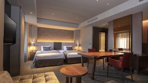 A modern hotel room with two beds, a dining table, and a TV. - Tokyu Stay Kyoto Sakaiza Shijo-Kawaramachi (Kyoto)