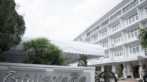 A hotel sign with a large, prominent entrance and a multi-story building in the background. - Dusit Hotel at Sakon Nakhon (Sakon Nakhon)