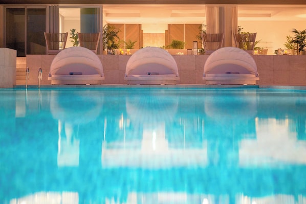 Seasonal outdoor pool, open 9:00 AM to 9:00 PM, pool umbrellas
