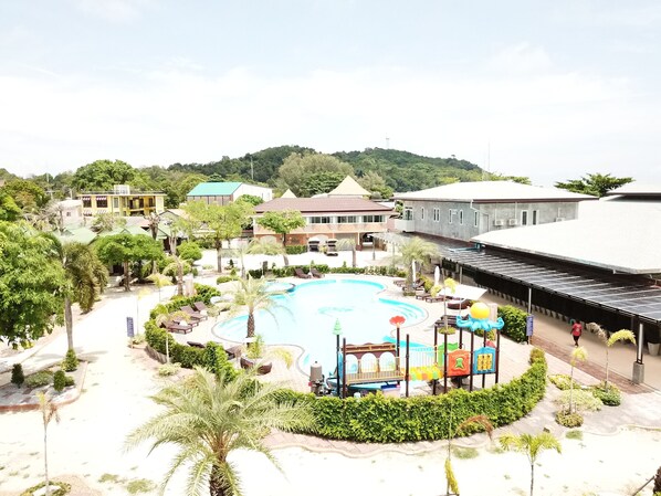 A resort with a large swimming pool, lounge areas, and a playground. - Walking Street Hostel by New Wave - Adults Only (Koh Lipe)