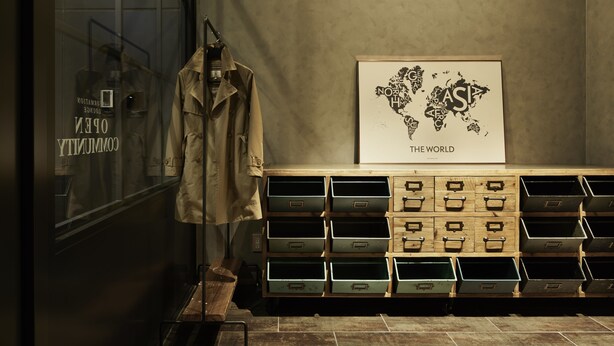 A display of clothing items and a world map on a wall. - the square hotel GINZA (Tokyo)
