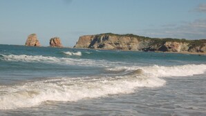 A coastal landscape with cliffs and waves.