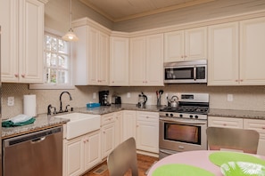 Kitchen features stainless steel appliances, granite countertop, and a window above the sink.