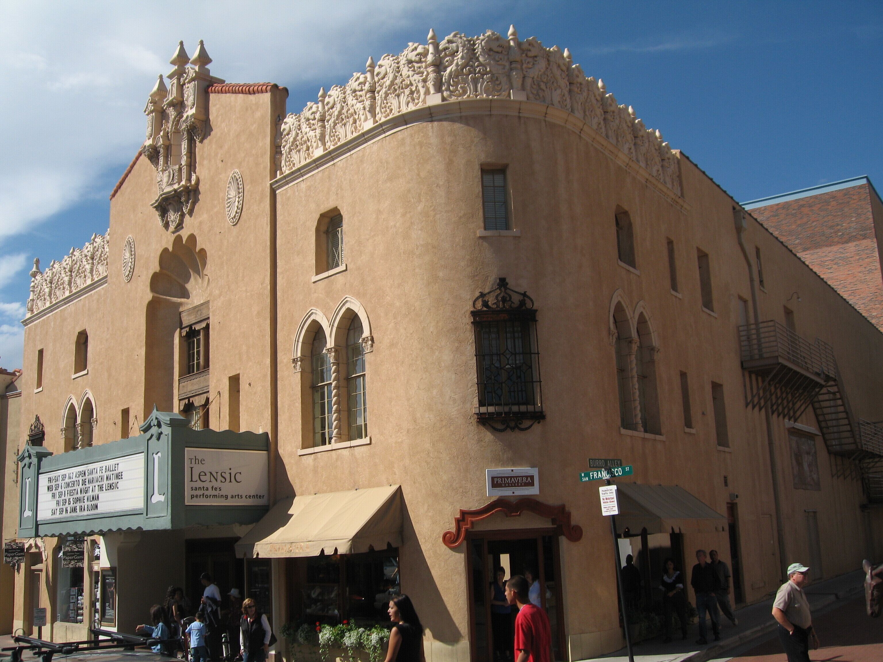 A historic building with ornate architectural details, including a theater marquee and a sign for 'Primavera'.