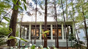 A house surrounded by tall trees and dense foliage. - NEW FALL RATES! Picturesque Cottage Retreat in Cassine Village, Seagrove Beach (Santa Rosa Beach)